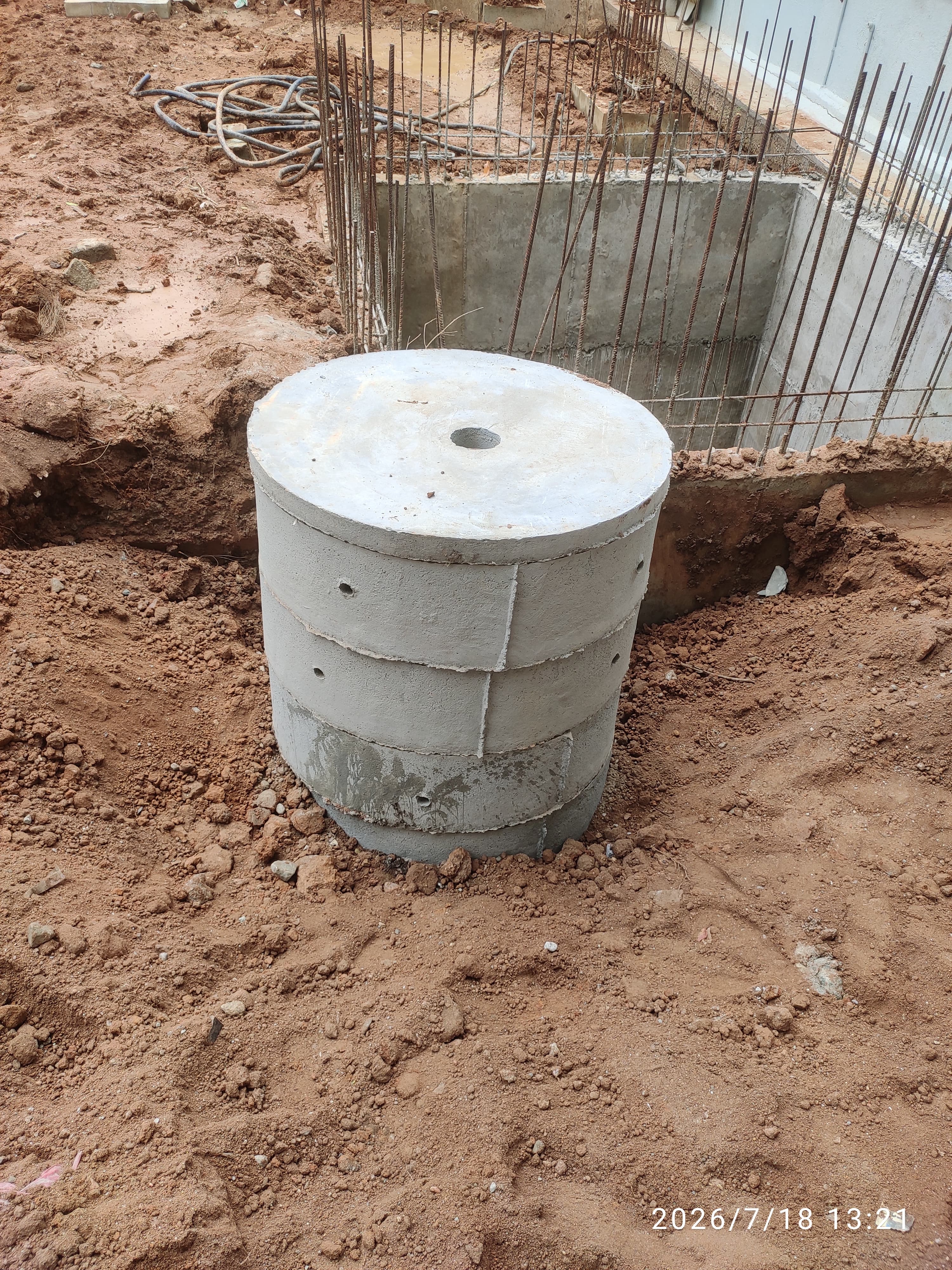 RCC ring slab cap being placed on top of a recharge pit in Bangalore