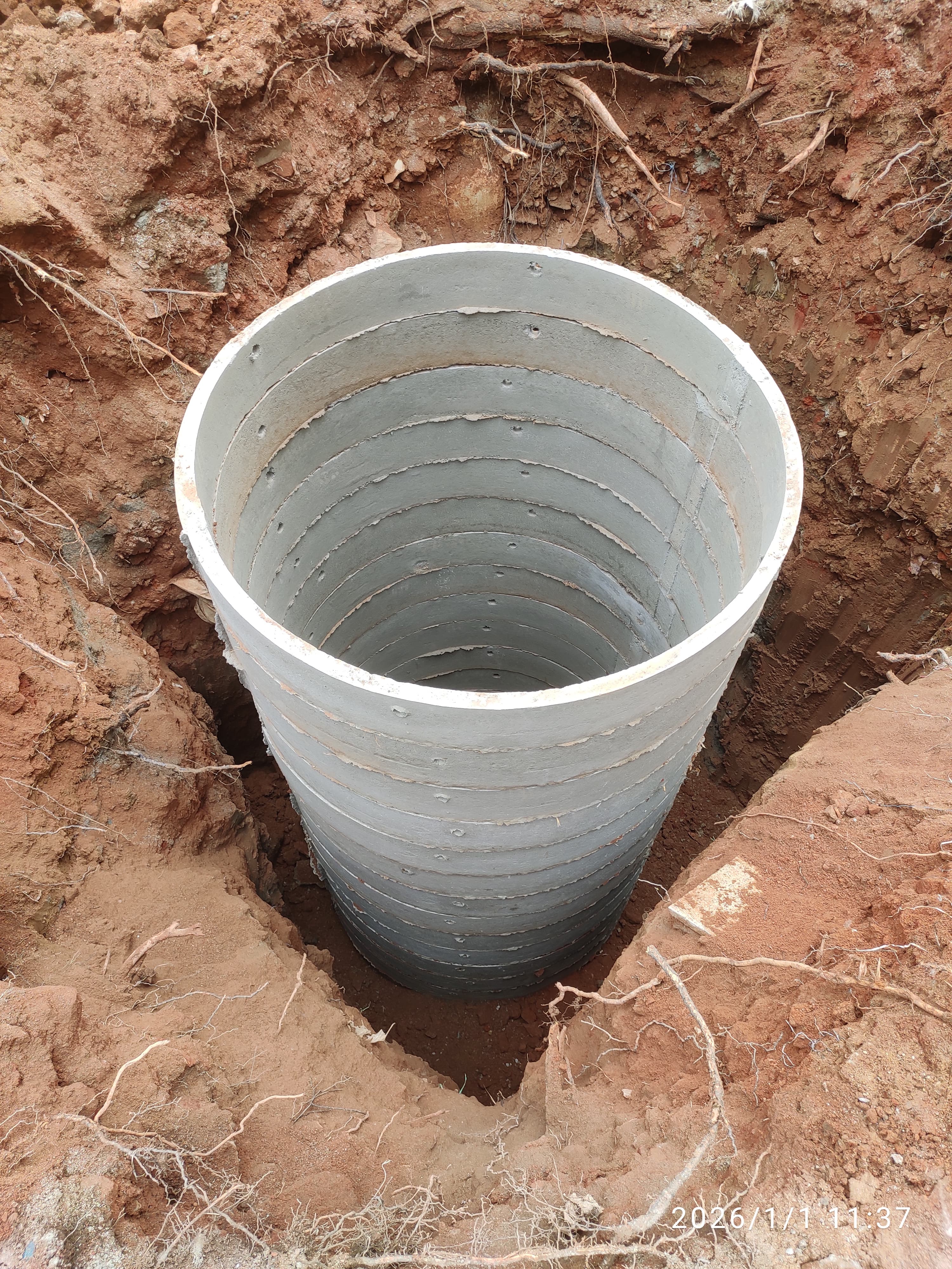 RCC rings being stacked during a rainwater harvesting pit installation in Bangalore